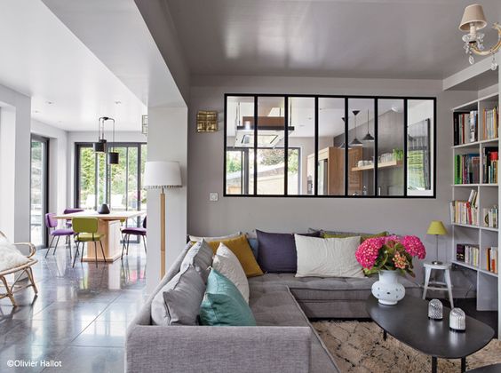 Elegant industrial-style glass partition wall between kitchen and living room for better light distribution.