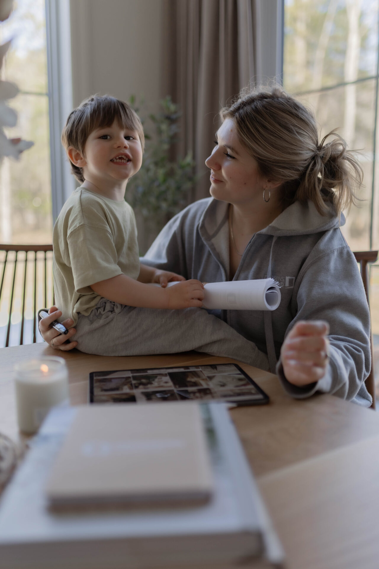 Mother and child reviewing a custom house plan blueprint as part of an online home design process