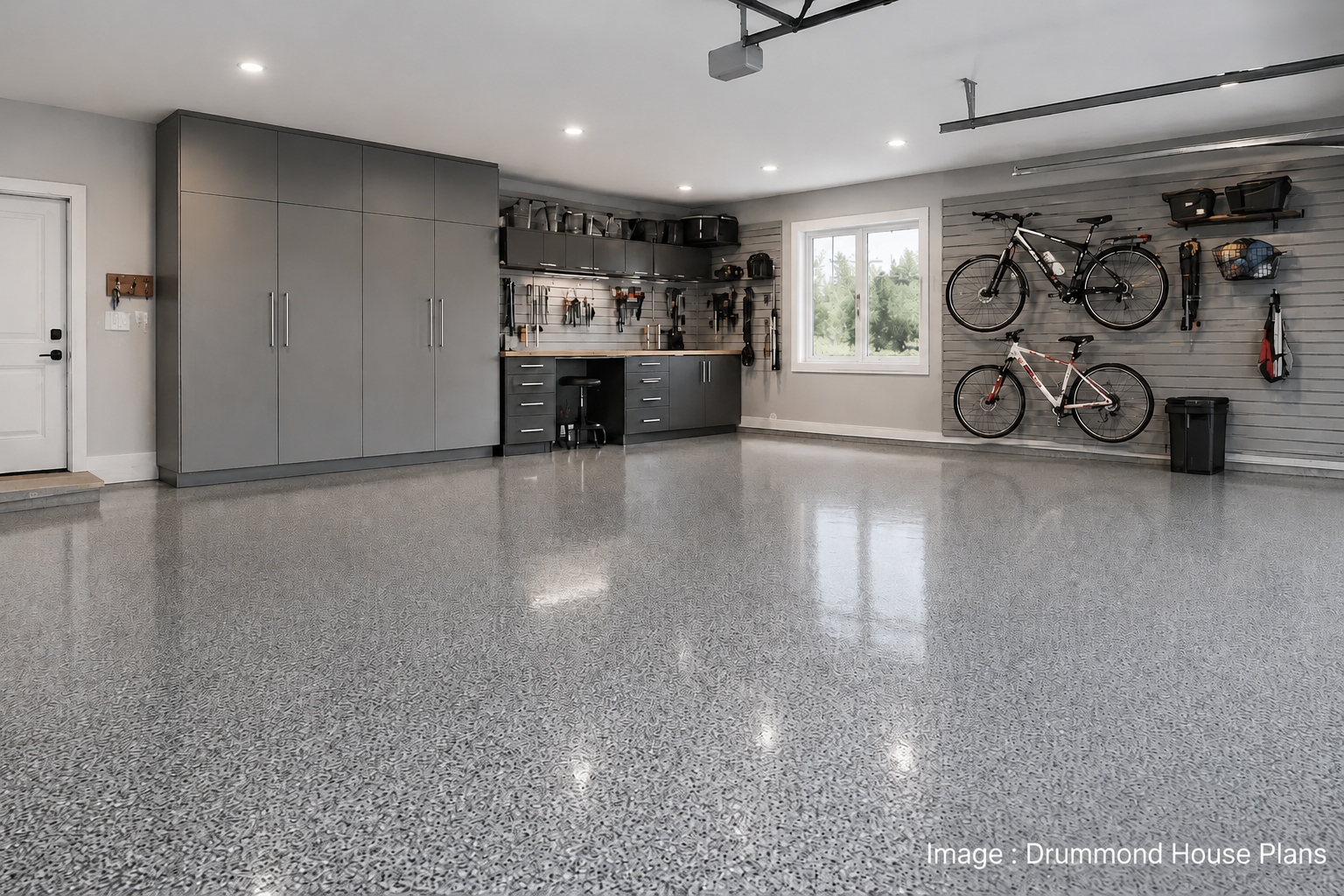 Modern garage interior featuring epoxy flooring, built-in storage cabinets, wall organization and a functional workspace designed to improve durability and everyday comfort.