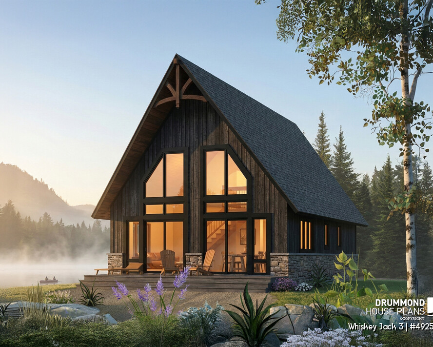 Small lakefront cabin plan Whiskey Jack 3 4925-V1 with loft 3 bedrooms large windows glowing at sunset in a natural setting