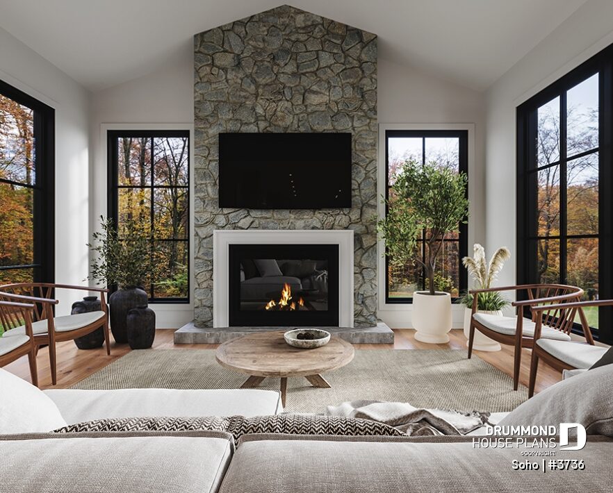 Great room with cathedral ceiling, floor-to-ceiling stone fireplace and large windows in the Soho (#3736) transitional house plan