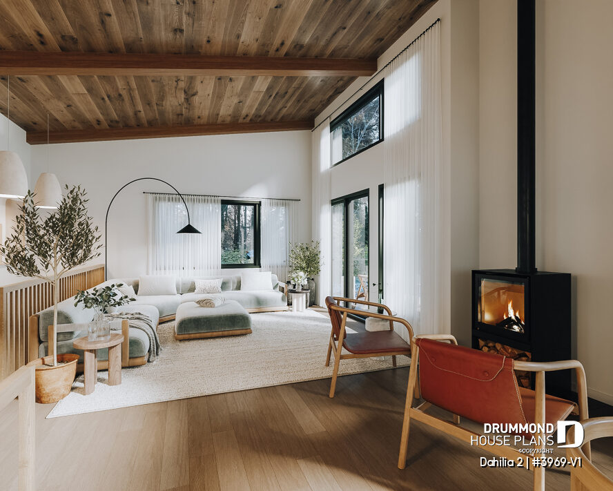 Vaulted open-concept living room with STÛV wood stove in the Dahilia 2 modern walkout basement cottage house plan for sloped lots.