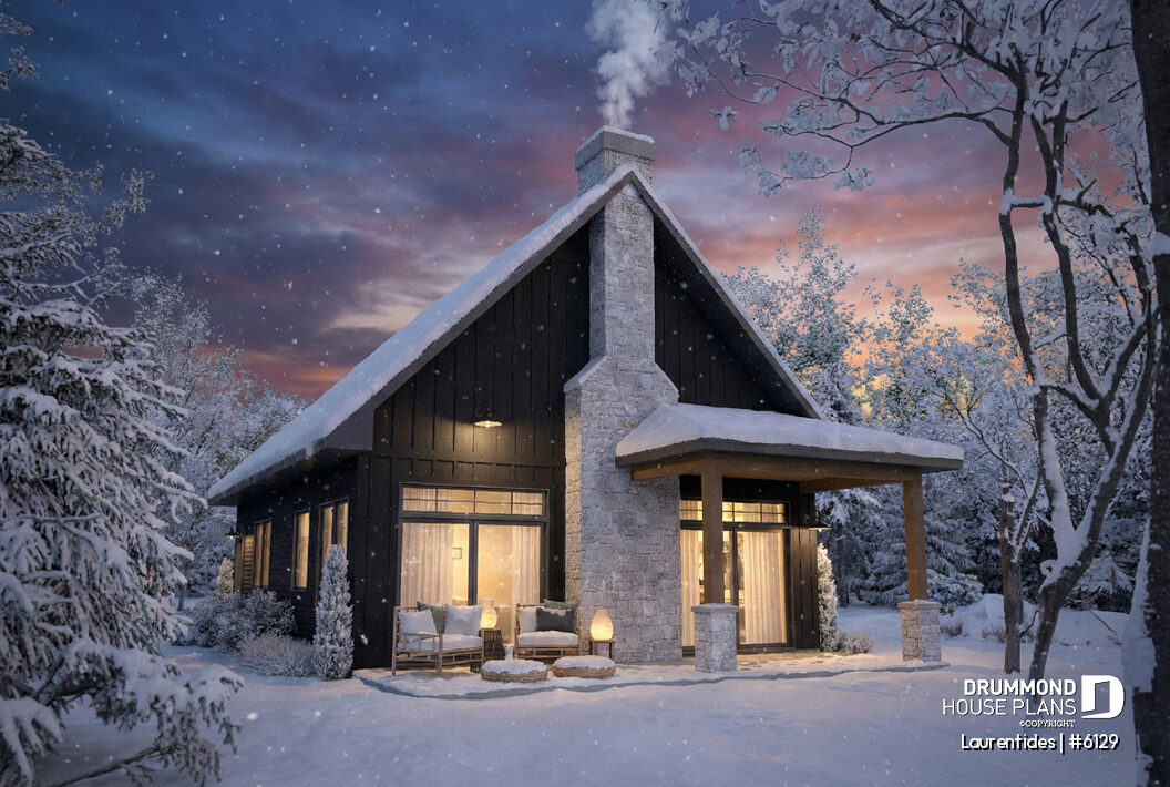 Modern rustic cabin Laurentides #6129 with steep gable roof, tall stone chimney, dark siding, and covered entrance in winter.
